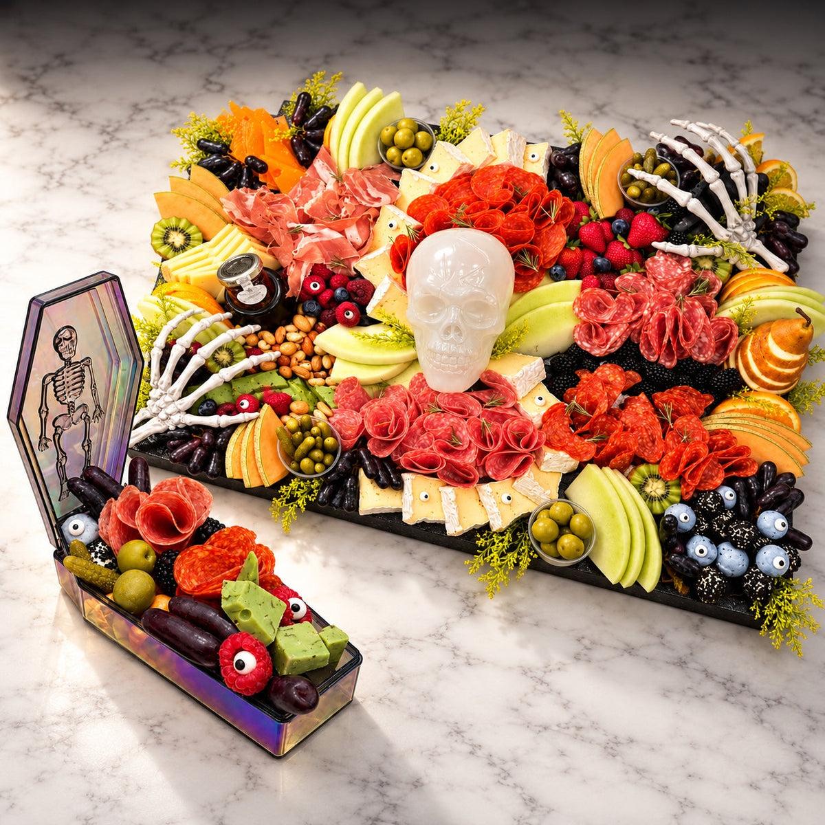 Halloween charcuterie collection featuring a coffin charcuterie box and large board on white marble