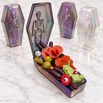 Halloween coffin charcuterie with upright decorative coffins on white marble